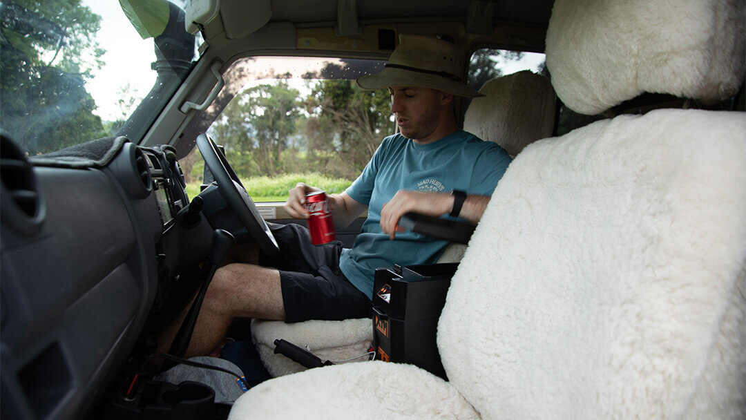 Father and daughter sitting under the shade on the beach