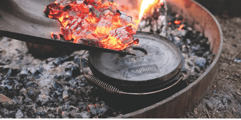 Cast iron camp oven cooking over an open fire