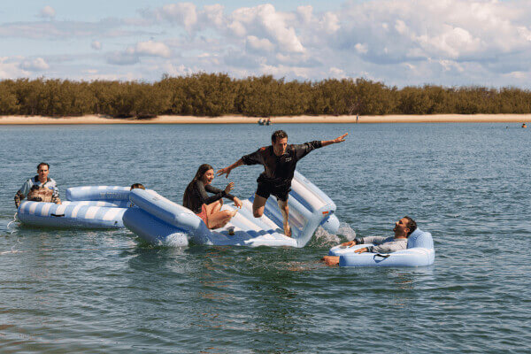 Kids playing with beach cricket and inflatables