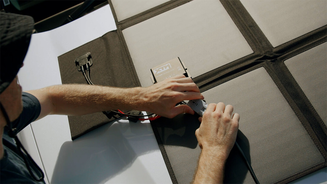 Man connecting the XTM solar panel