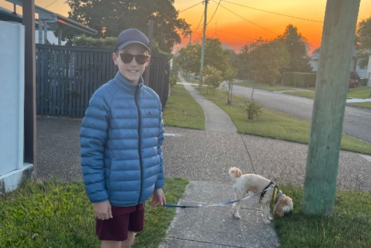 Zac wearing his macpac puffer jacket while walking the dog at sunset