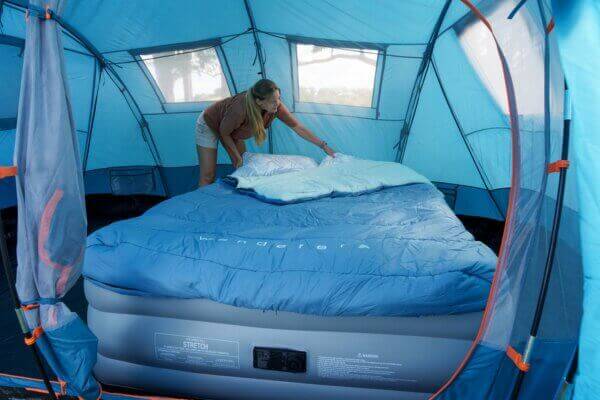 Kids sleeping comfortably in a camping tent