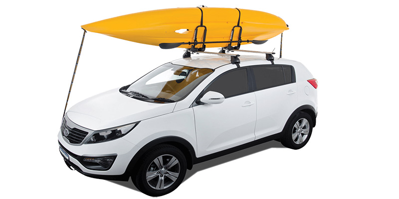 Kayak strapped to roof of vehicle
