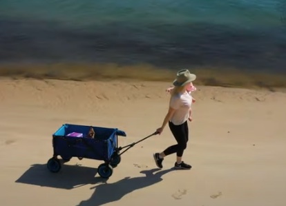 Walking along the beach with the Wanderer camp cart