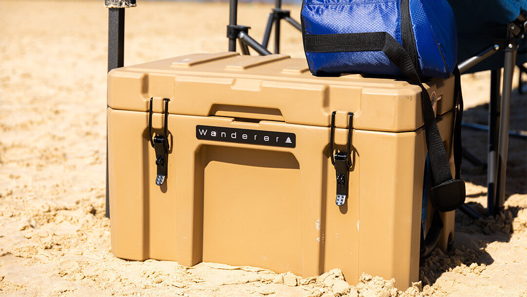 Father and daughter sitting under the shade on the beach