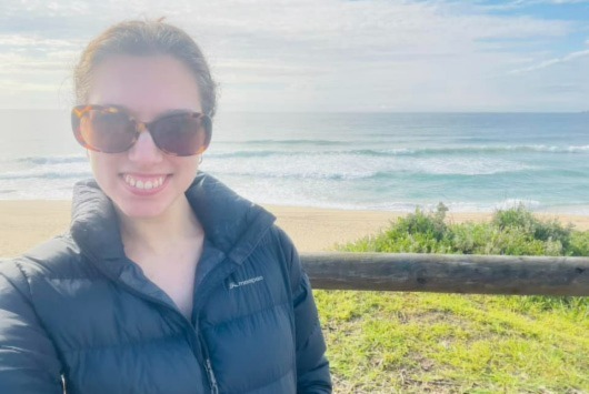 Tiegan wearing her macpac halo jacket at the beach