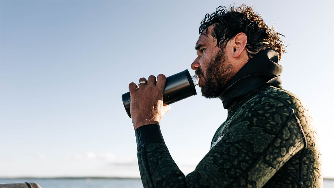 Diver drinking from a YETI® water bottle