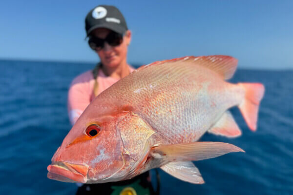 Angler holding a large Red Emperor